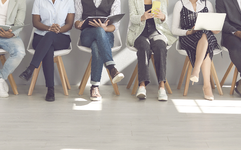 People sitting in a row of chairs