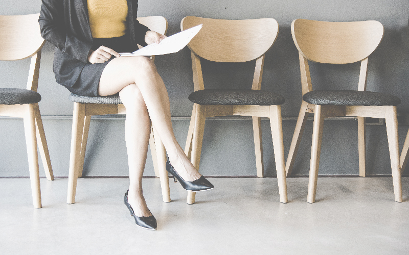 Partial view of women sitting in a chair